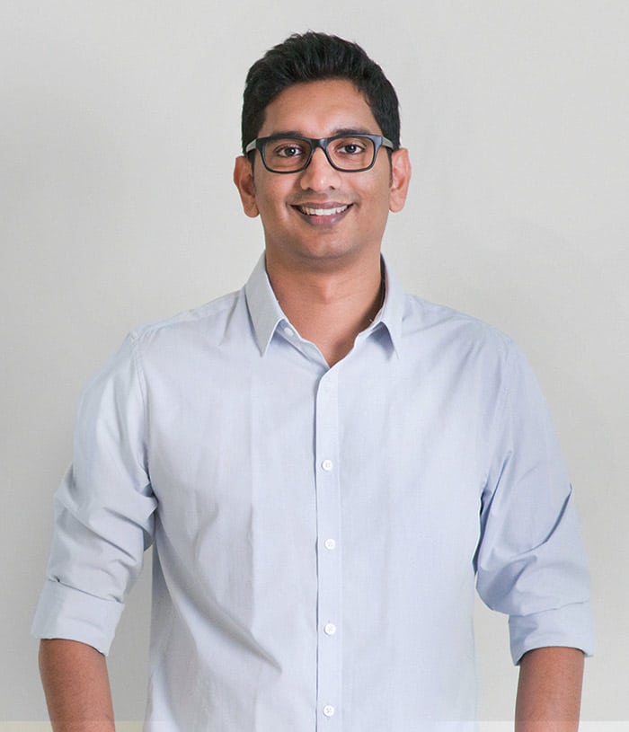 Man with glasses in shirt smiling