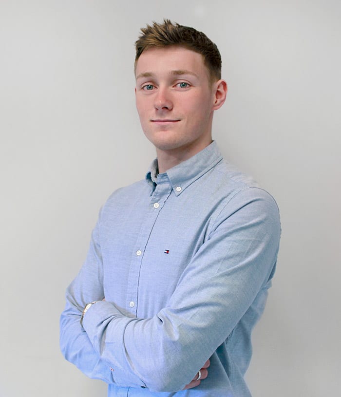 Man in blue shirt with arms crossed